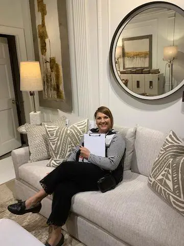 A woman sitting on top of a white couch.